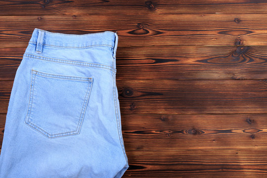 blue denim jeans  on wooden background .