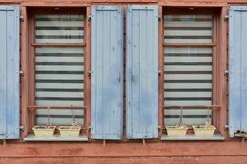 Fenêtres aux vieux volets bois bleu ciel sur vieille façade bois saumon à Amiens (80000), département de la Somme en région des Hauts-de-France, France