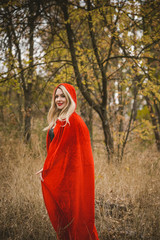 Woman wear red carnival cloak, concept of simple Halloween ideas 