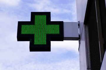 shop green cross logo Pharmacy sign in street modern building store