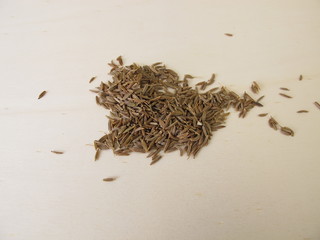 Caraway seeds, Carum carvi, on a wooden board