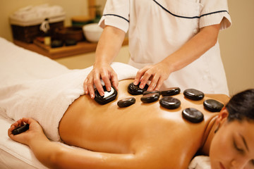 Relaxed woman enjoying in lastone therapy at the spa.