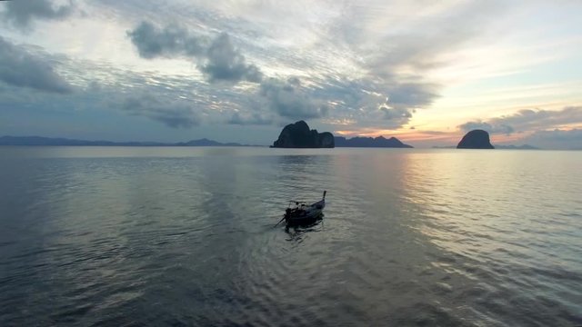 ARIAL: longtail boat in thailand, during sunrise