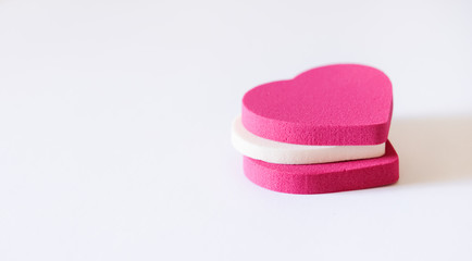 Assorted pink cosmetic sponges.