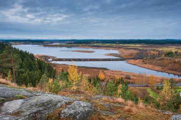 Fototapeta na wymiar View from Mount Paaso in Karelia near Sortavala to the surrounding nature, forest and Lake Ladoga in golden autumn