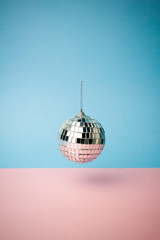 Disco ball on a colored blue background. Minimal concept