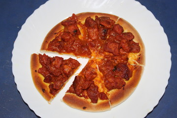 Delicious spicy meat pizza cut into slices