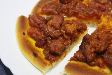 Delicious spicy meat pizza cut into slices