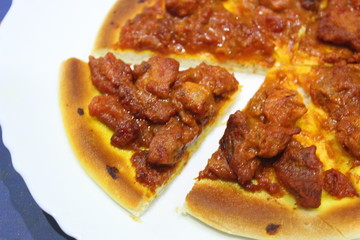 Delicious spicy meat pizza cut into slices