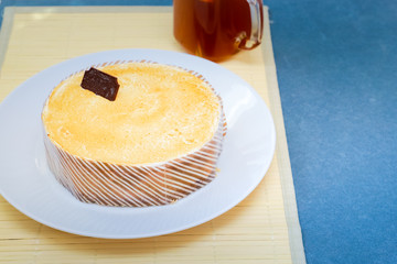 The contrast of a straw napkin and a graphite blue countertop is balanced by a white dish with a...
