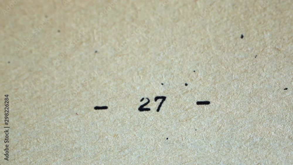 Aufkleber flicking through old typescript book page numbers close-up