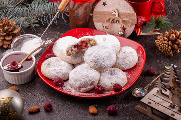Traditional Christmas cookies biscuits snowballs covered icing sugar povder with almond nut, nutella chocolate an raspberry jam. Christmas New Year ornament decorations.