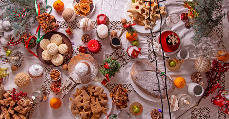 Celebration Christmas Eve. Traditional Christmas sweets cookies biscuits pastry dessert for family. Christmas New Year ornament decorations. Christmas Eve table