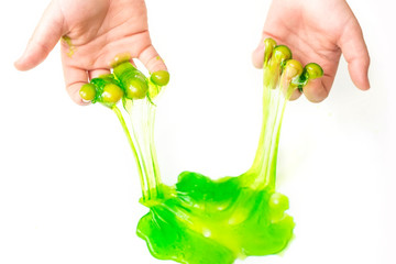 Modern toy called slime. Mucus in children hand on a white background. Selective focus.	