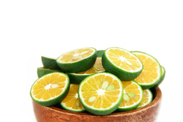 thin slices of green natural fresh mandarin orange in a wooden plate