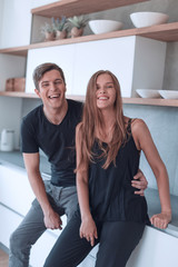 beautiful young couple standing in home kitchen