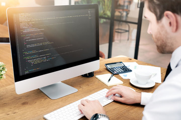 Programmer working on code in office