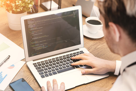 Programmer working on code in office