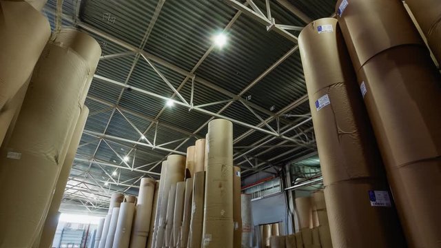 motion along storehouse with paper rolls at plant timelapse