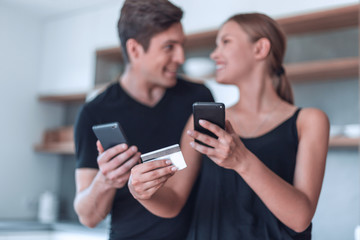 young couple makes online payment on smartphone