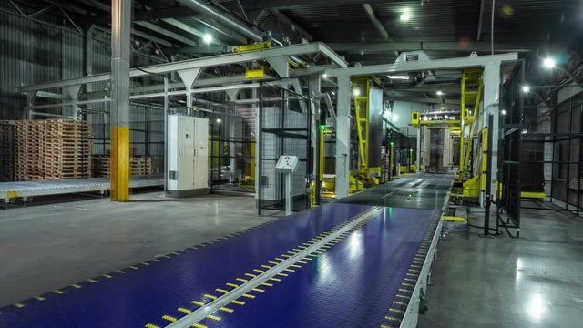 cardboard transported by conveyor in workshop timelapse