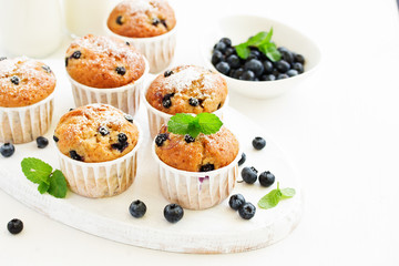 Oat muffins with blueberries on a dark background.
