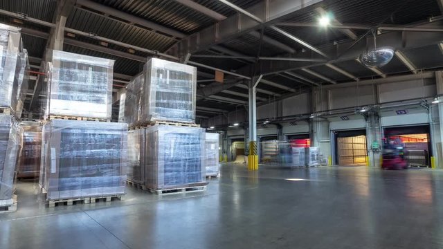 cardboard covered with foil in light warehouse timelapse