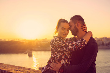 romantic couple kissing at sunset