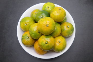 Fresh Green Tangerines In The White Bowl