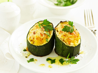 Baked zucchini stuffed with rice and vegetables.