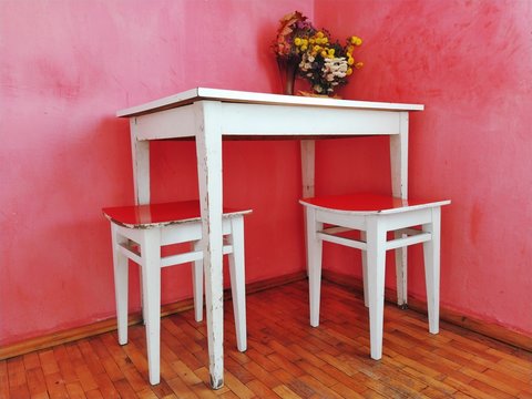 old table and chairs in red room