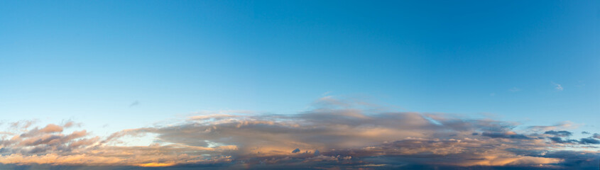 Fantastic clouds against blue sky, panorama
