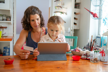 Mother paying with credit card from home	