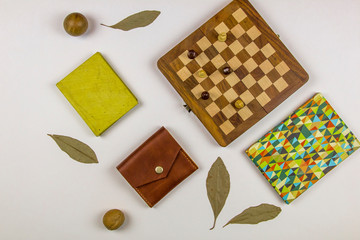 chess and notebooks on a white background, top view