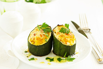 Baked zucchini stuffed with rice and vegetables.