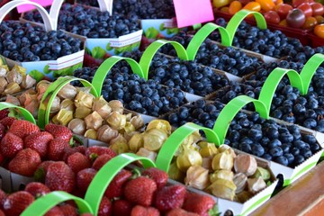 Picture of berries in small baskets for sale on a fresh morning market. Beautiful colors.