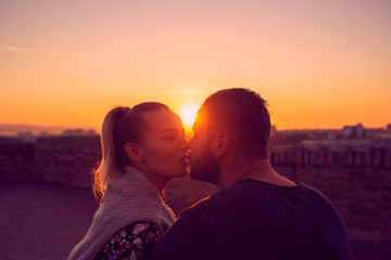 Fototapeta premium Couple in love kissing at evening in sunset