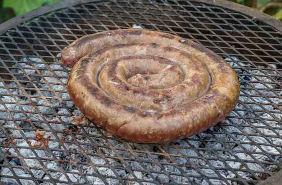 Boerewors sausage is a traditional South African dish cooked outdoors over an open fire image with copy space in horizontal format