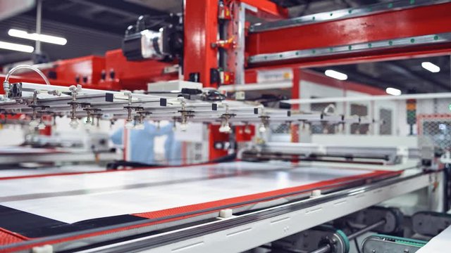 production of solar panels, Industrial robot working in factory,Conveyor Tracking Controler of robotic hand. Closeup video.