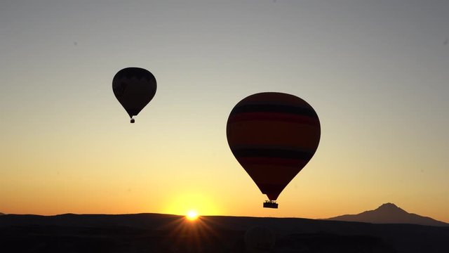 2 hot air balloons at sunrise in Cappadocia, Turkey seen from another ballon