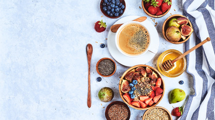 Fototapeta na wymiar Healthy breakfast, oatmeal with blueberries, strawberries, berries, figs, flax, chia seedsand honey. Top view, flat lay