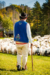 Traditional Polish Highland Shepherd in Regional Clothing at Sheep Pasture
