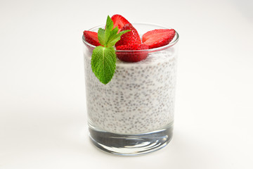 Chia pudding with strawberry and mint on a white background. Space for text or design.