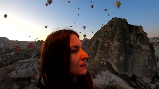 Happy woman enjoying a hot air balloon ride in Cappadocia, Turkey
