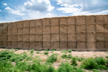 Fototapeta premium Blurred view of hay stacks