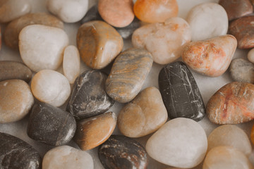 Stones and pebbles as background. Multicolor pebbles at the seaside close up view. 