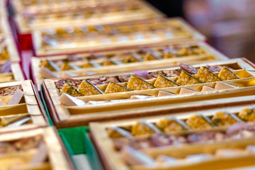 A mixture of various Indian sweets packed in a box. Peda, laddu, mithai, diwali sweets