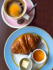 Continental breakfast with croissants, fruit jam, butter, coffee