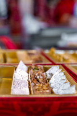 A mixture of various Indian sweets packed in a box. Peda, laddu, mithai, diwali sweets
