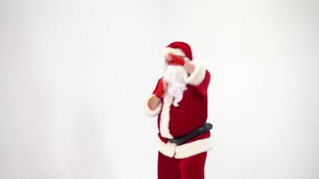 Christmas. Santa Claus on a white background in red bows for boxing and kickboxing fulfills blows. The image of a fighter.